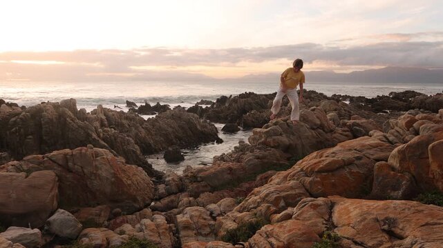 young boy exploring rocky coastline of DeKelders, Gansbaai, South Africa