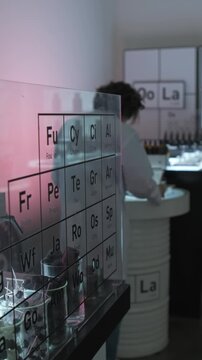 Dubai, UAE - 07 07 2025: Male scientist holding test tube in laboratory with pink neon light