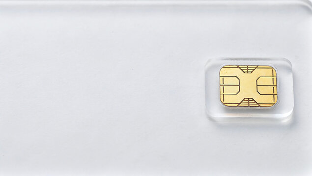 Smart card microchip metal plastic gold white matte surface landscape close-up framing