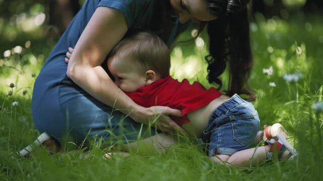 Running toddler in red shirt spotting woman in blue dress running across grass, leaping seeking hug