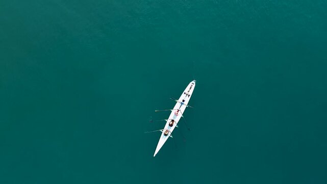 Aerial View of Rowing Team Training on Deep Blue Water
