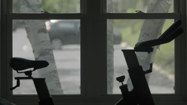 Home fitness workout stationary bikes by window, home gym