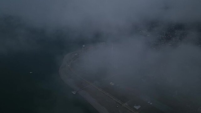 Drone Flying Out of Clouds Above Batumi City
