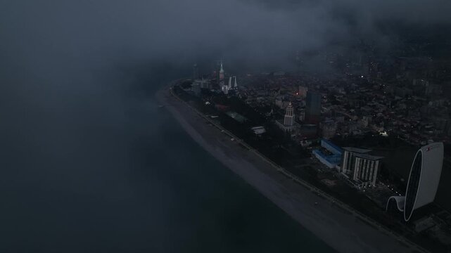 Drone Emerging From Clouds Over Batumi at Dusk