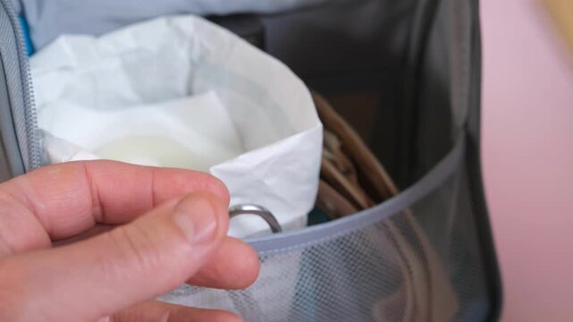 Stoma care preparation kit handled with medical supplies including pouch, scissors, gauze and barrier ring for hygiene and treatment.