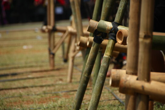 People use bamboo stilts in a traditional outdoor game celebrating Indonesian culture and community entertainment.