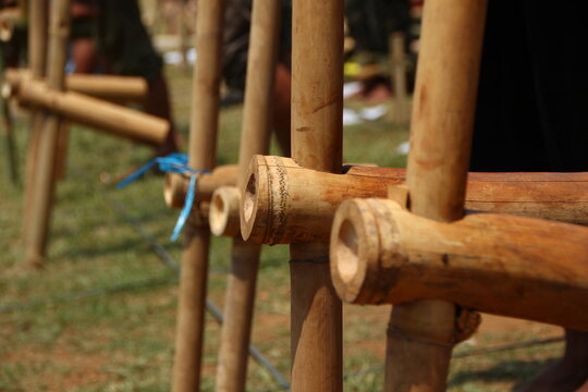 People play traditional bamboo stilts outdoors, showcasing balance, coordination, and Indonesian cultural heritage games.