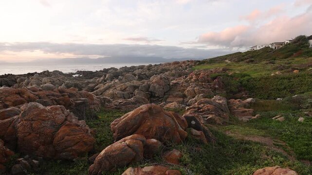  rocky coastline of DeKelders, Gansbaai, South Africa at sunset