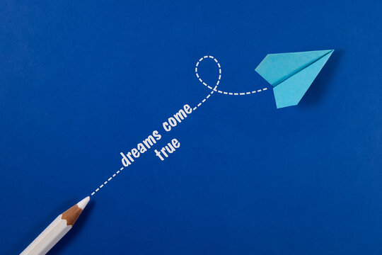 dreams come true note with origami plane	