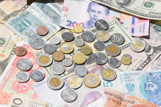 collage of different world paper currencies. Background of banknotes and different coins, Ukrainian hryvnia, US dollars, Polish zloty and Egyptian pounds. Financial background of banknotes 