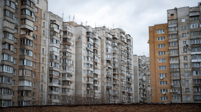 Rows of old soviet-era apartment buildings under a cloudy sky