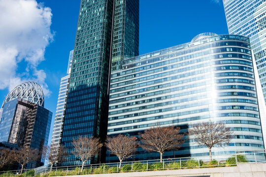 Curved towers and blue sky shape La Defense Paris France, where glass skyscraper architecture defines an urban business district skyline