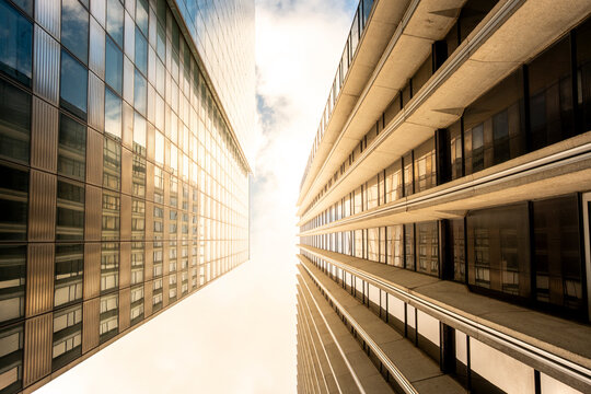 Sunlight pulls through a narrow glass corridor in La Defense Paris France, turning business district architecture into an urban perspective