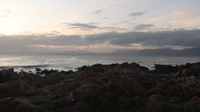 rocky coastline of DeKelders, Gansbaai, South Africa at sunset
