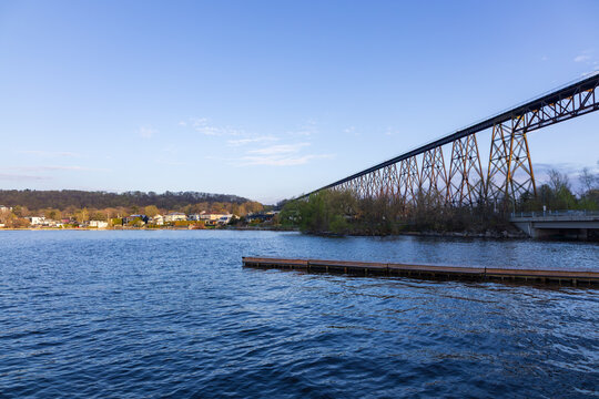 View of the 1908 railway trestle bridge over the Cap-Rouge Bay and the St. Lawrence river, with a wooden pier in the foreground seen during a spring morning, Cap-Rouge area, Quebec City, Quebec