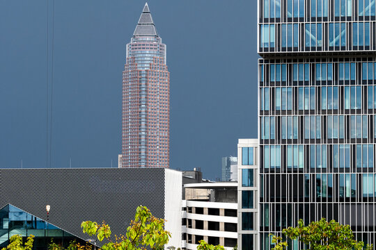 MesseTurm rises beyond facade layers in Frankfurt Germany, placing business district architecture within a compact urban skyline