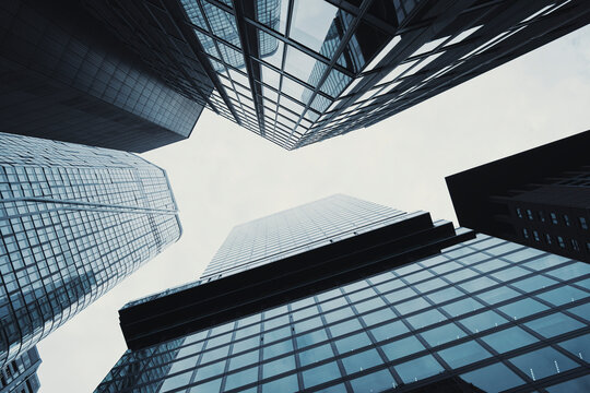 Glass towers lean into an urban sky view in Frankfurt Germany, where business district architecture sharpens reflection and perspective