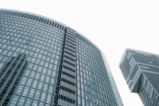 Glass skyscrapers curve upward in Frankfurt Germany, where business district architecture frames an urban sky view with strong scale