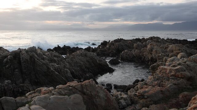 rocky coastline of DeKelders, Gansbaai, South Africa at sunset