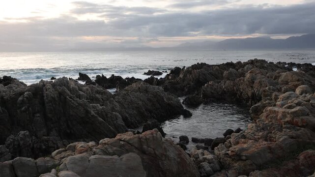 rocky coastline of DeKelders, Gansbaai, South Africa at sunset