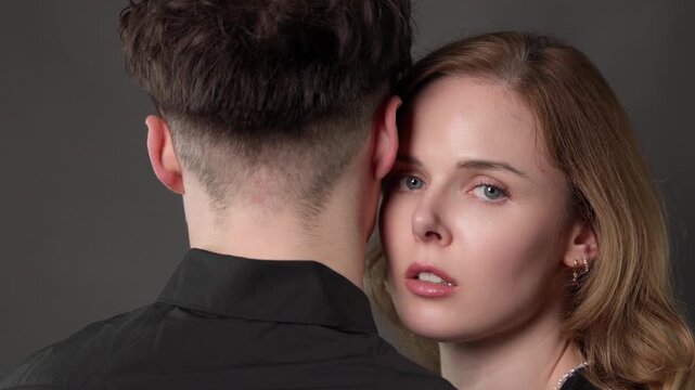 Romantic connection and intimacy, a young couple looking at each other with love and affection in a close up studio shot. This footage can be used for commercial projects related to relationships, dat