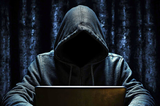 Faceless hacker wearing hoodie working on laptop in dark environment cyber security concept. Ai Generative