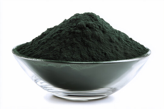 Green spirulina powder heap in a glass bowl isolated on white