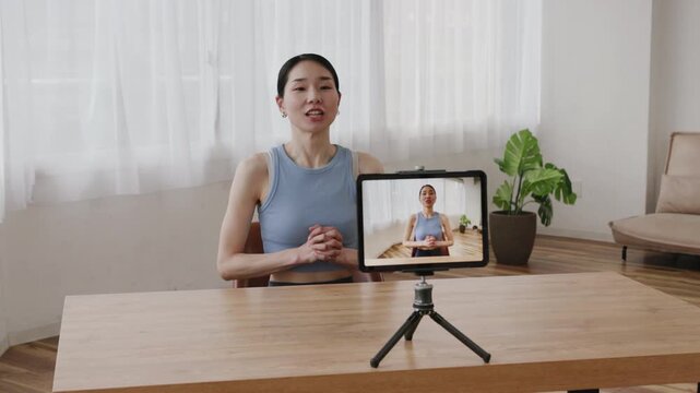 Asian Woman Yoga Instructor Live Streaming Online Yoga Lesson Using Tablet