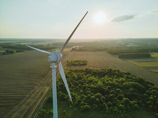 Aerial view of wind turbine over rural farmland © AlexGo