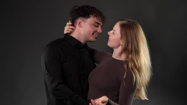 A romantic couple embracing with affection and intimacy, expressing love and connection in a studio setting. This footage can be used for projects related to relationships, emotions, and modern romanc