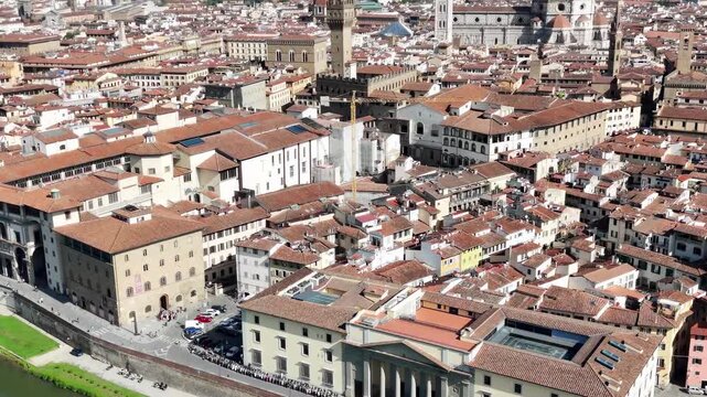 Aerial drone view of Florence city center around historic Lungarni riverside walkways and Arno River bridges