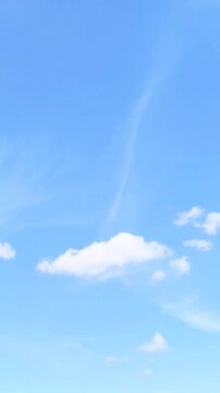 Minimalist single white cloud on clear blue sky background with large copy space for text concepts of freedom peace of mind and serenity