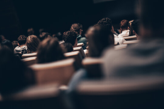 Rear view of unrecognizable people in audience at the conference hall. Business and entrepreneurship symposium