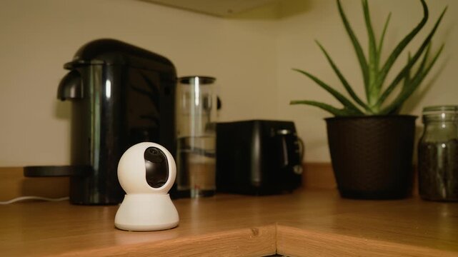Smart kitchen AI camera monitoring coffee consumption and caffeine intake habits. Connected wellness device supporting healthy lifestyle tracking near coffee machine in modern home interior. Personal
