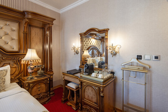 Luxury classic hotel bedroom interior with wood carved furniture