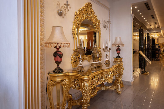 Luxury gold baroque console table with ornate mirror and lamps