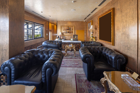 Sophisticated cigar lounge with black leather chesterfield sofas