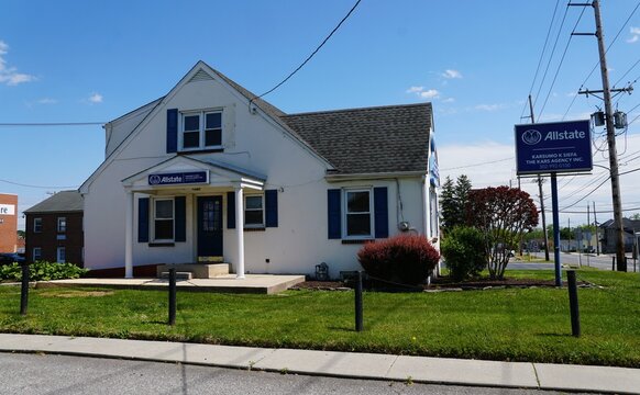 Wilmington, Delaware, U.S - May 11, 2026 - Small building housing Allstate Karsumo K Siefa insurance agency with porch, signage, roadside sign, and maintained lawn.