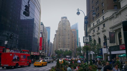 New York City, New York, USA - September 2013: Typical New York street with buildings either side leading to a split in the road, red delivery trucks and yellow taxis © Michael