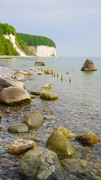 Famous white chalk cliffs and rocky Baltic Sea coastline in Jasmund National Park on Rugen island, Germany. Iconic natural landmark and coastal travel destination concept.
