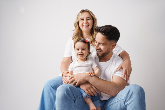  Happy family sitting together in a modern living room