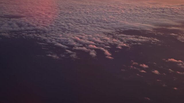 Pastel sunset over vast cloud layer seen from high altitude