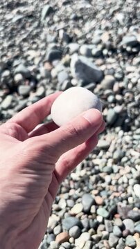 Hand Picking Up Beach Pebble POV Vertical Video (9:16)