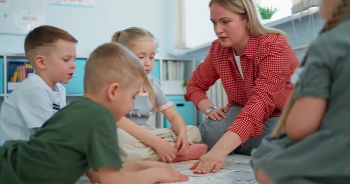 Teacher guiding young children seated on classroom floor during an interactive group learning activity with maps, books, and colorful supplies