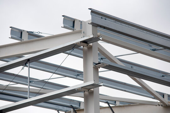 Construction project shows metal structure under assembly in an urban area during cloudy weather