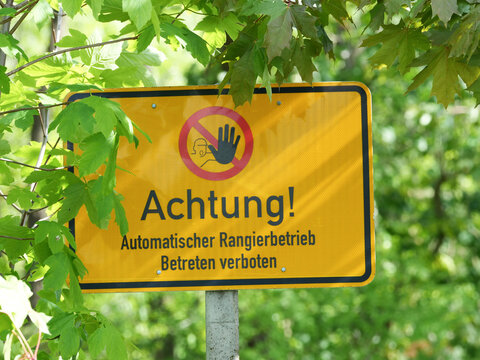 The image shows a warning sign that reads: &ldquo;Caution! Automatic shunting in progress. No entry.&rdquo;