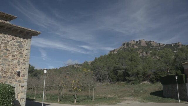 Sant Llorenc mountain sky clouds jib crane Polecam buildings pan left 2