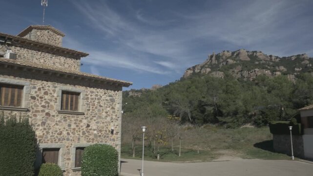 Sant Llorenc mountain sky clouds jib crane Polecam buildings pan left