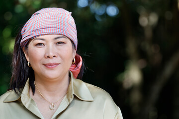 Fototapeta premium Portrait of woman wearing the traditional Khmer Krama on her head. Siem Reap. Cambodia.