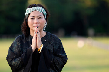 Naklejka premium Portrait of woman wearing the traditional Khmer Krama on her head. Siem Reap. Cambodia.